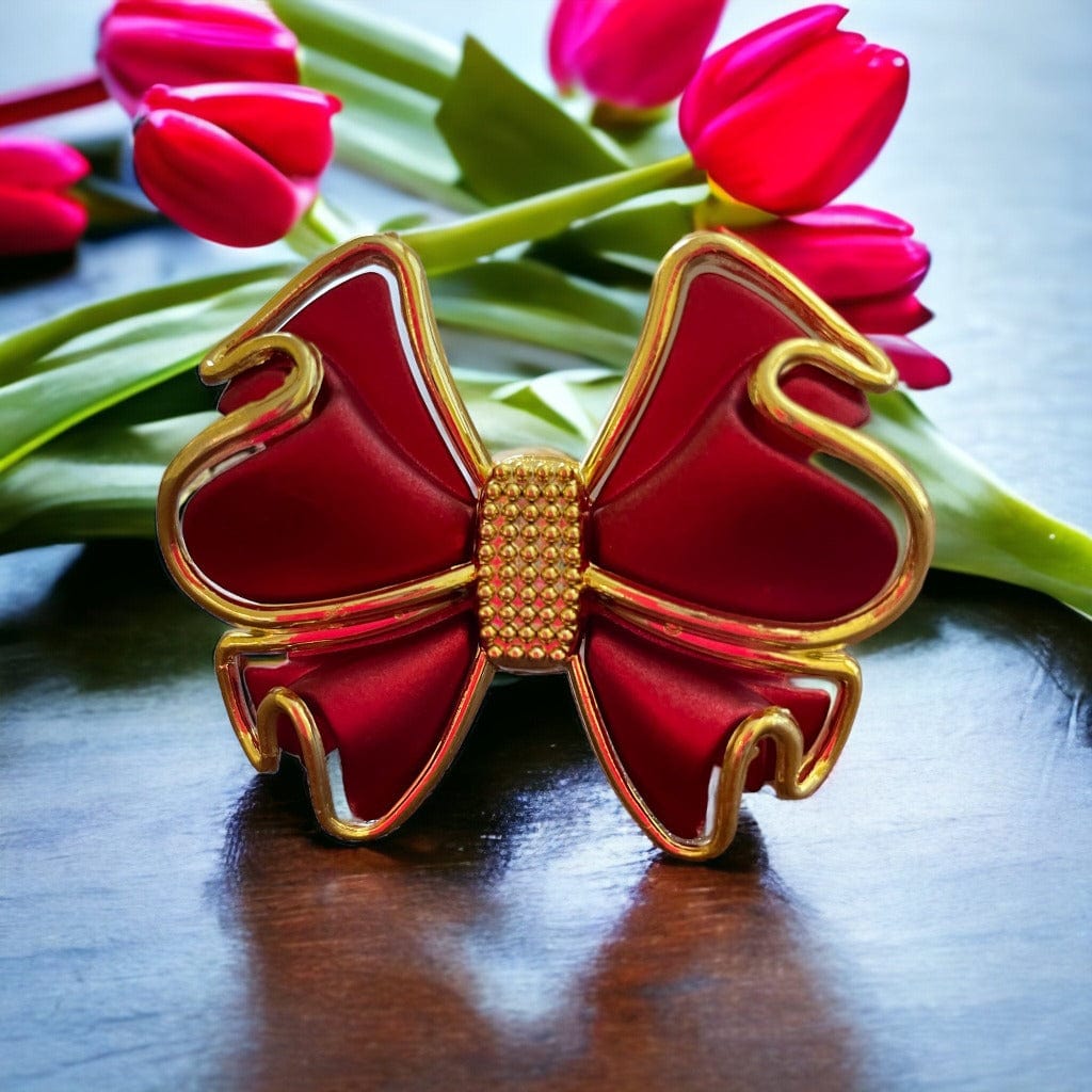 Napkin ring featuring a large red bow with gold trim made of alloy.