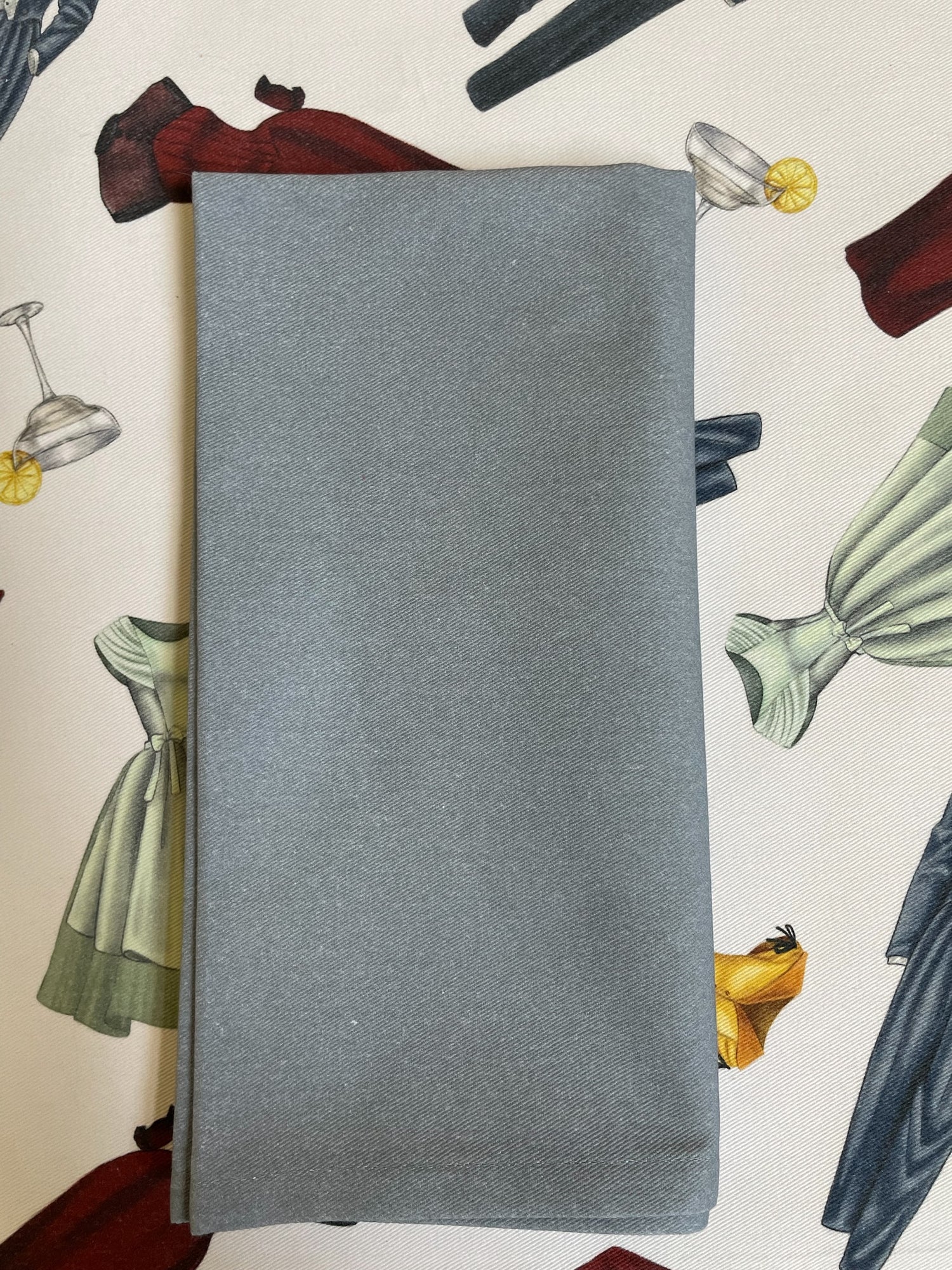 Brown Napkins with a buble bee napkin ring laying on top of Stone