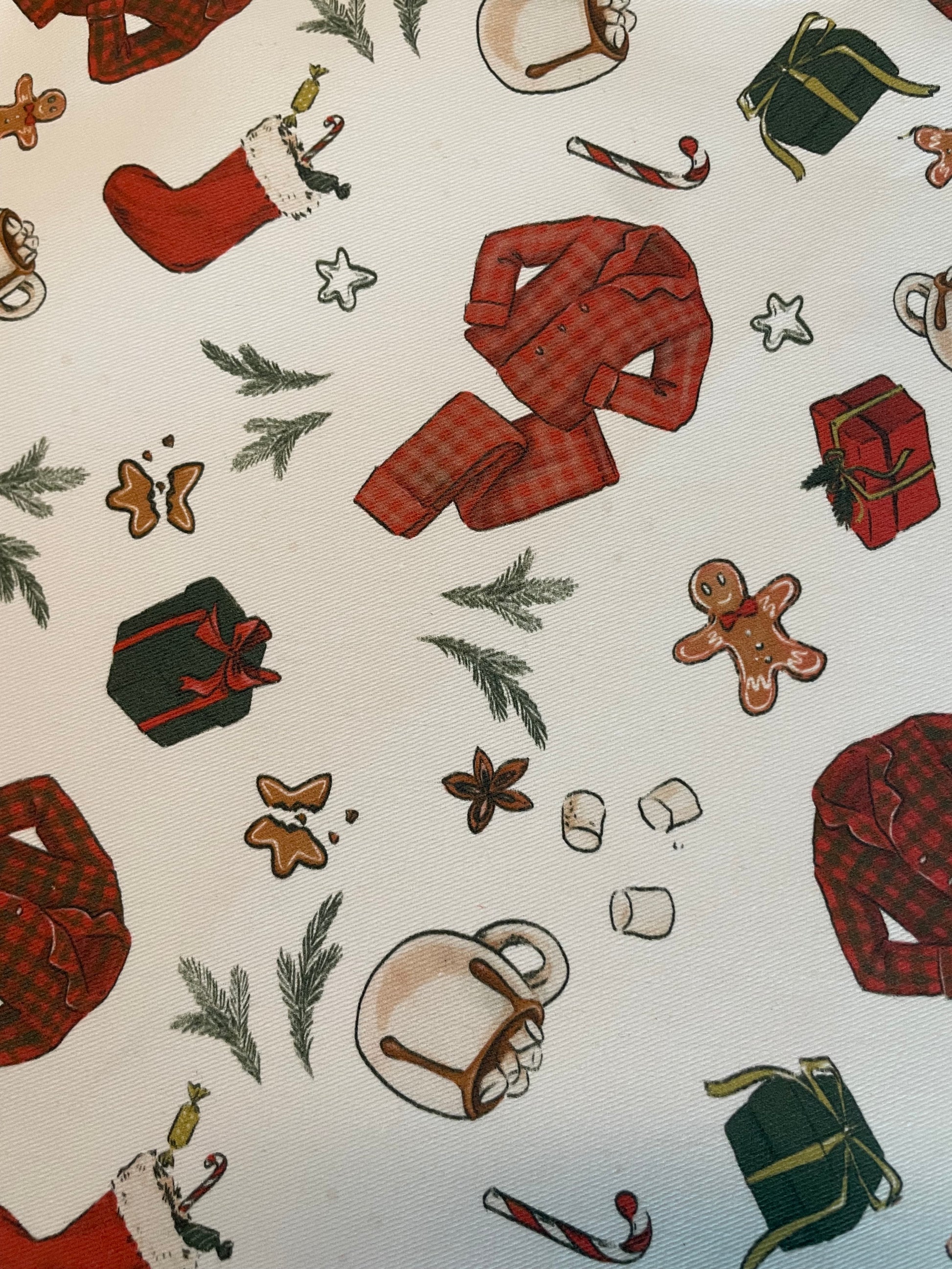 Christmas-themed pattern with red shirts, stockings, and cookies on a white background