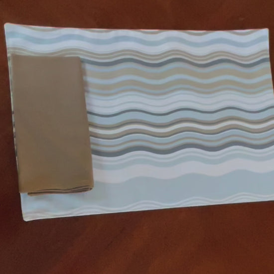 Video showing the reversible aspects of the Beach House Brunch reversible placemat.