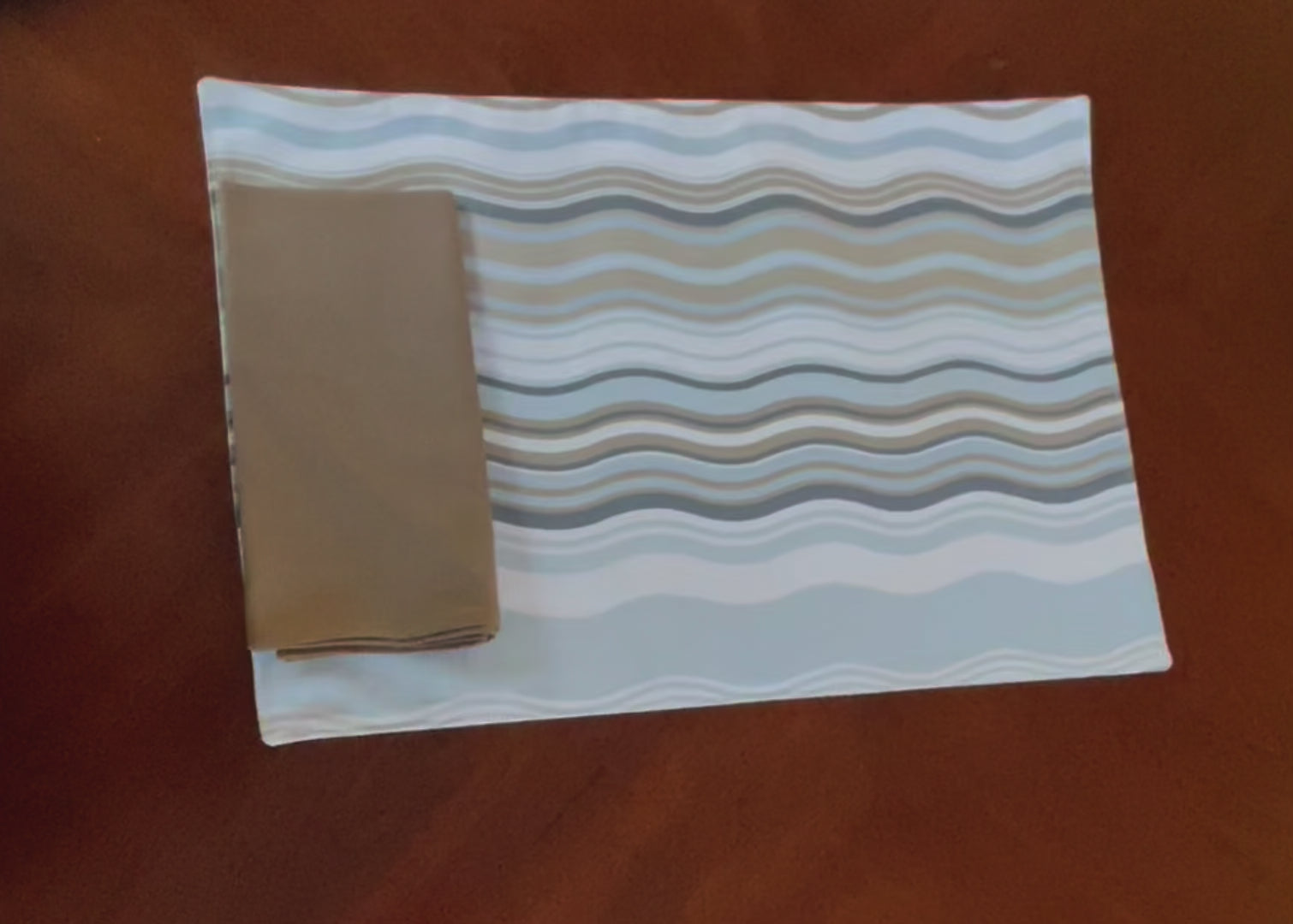 Video showing the reversible aspects of the Beach House Brunch reversible placemat.